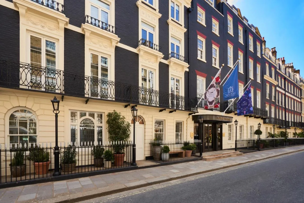 A row of Mayfair buildings with flags outside The Mayfair Townhouse in London
