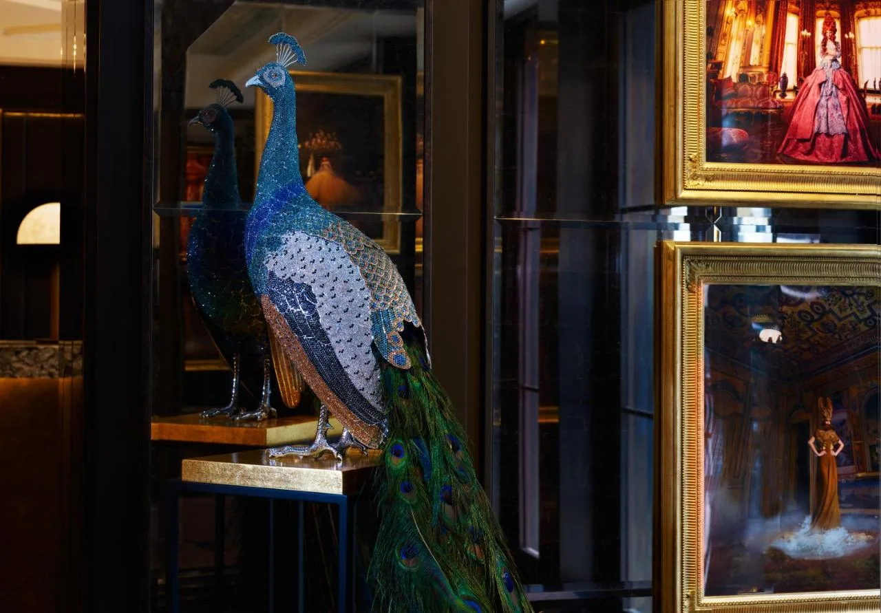 A peacock statue on display in a window at The Mayfair Townhouse in London